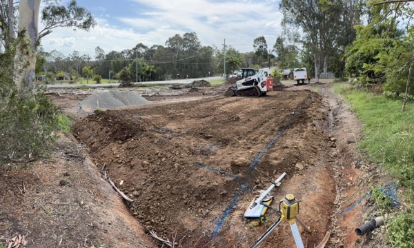 A cleared site with trenching and survey markers in place