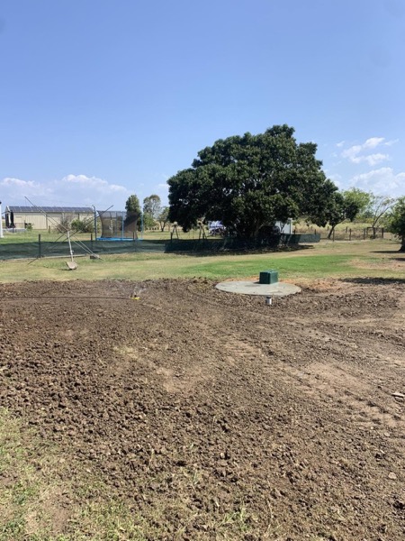 A cleared paddock with new septic access lids set in the ground