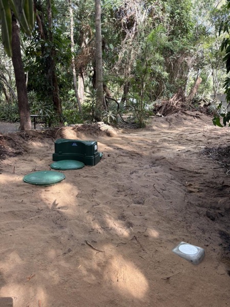 A bush block with septic access lids set into cleared ground