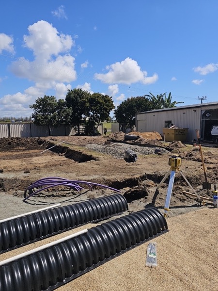 A trench with corrugated drainage pipe laid alongside