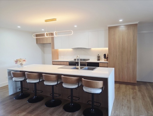 A finished kitchen with an island bench and stools